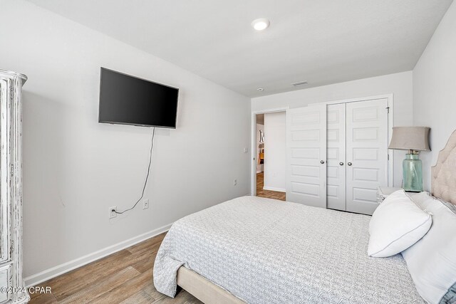 bedroom featuring hardwood / wood-style flooring and a closet