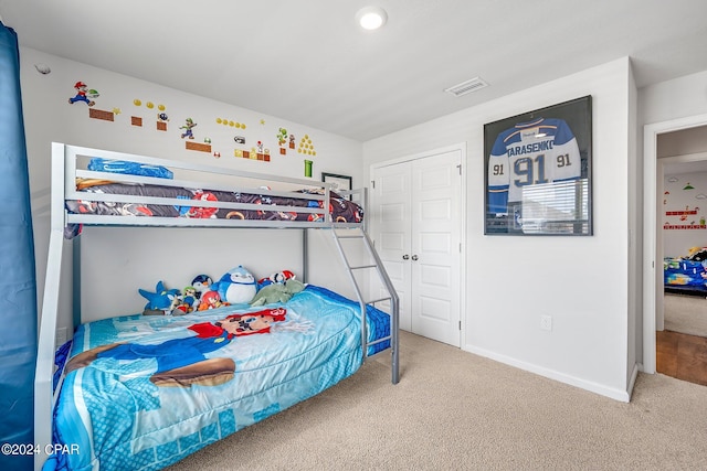 bedroom with a closet and light carpet