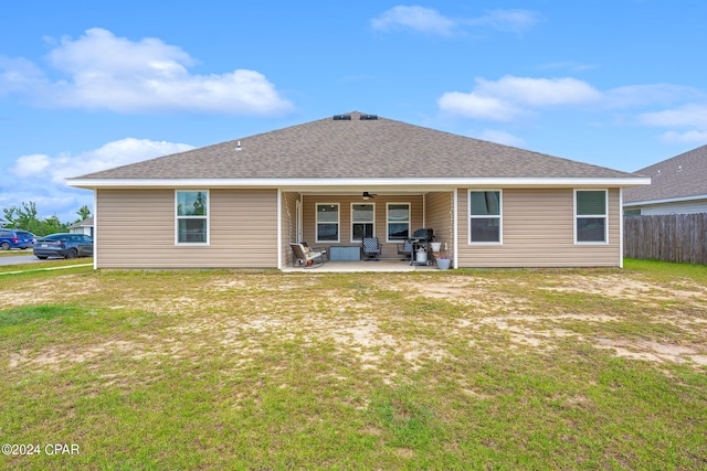 back of property featuring a patio and a yard