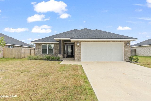 view of front of house featuring a garage and a front lawn