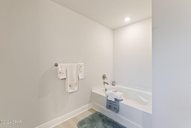 bathroom featuring a bath and wood-type flooring