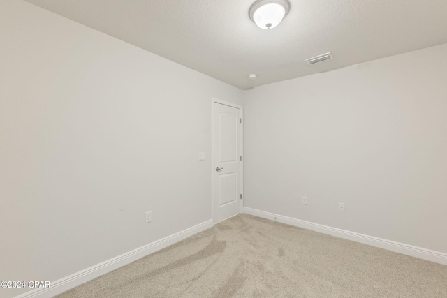 unfurnished room with light colored carpet