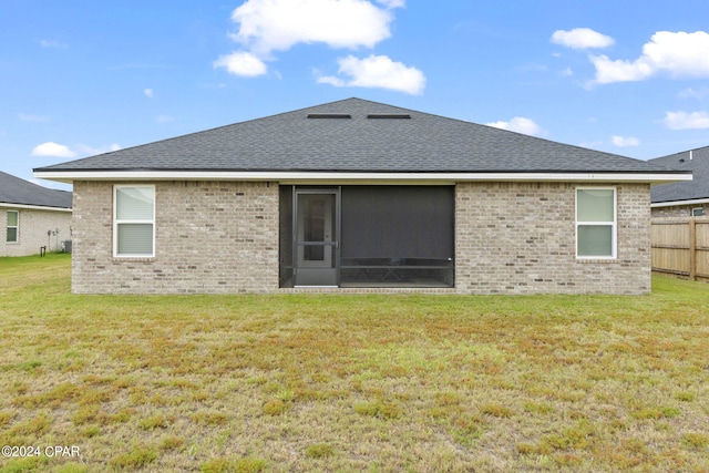 rear view of property with a yard