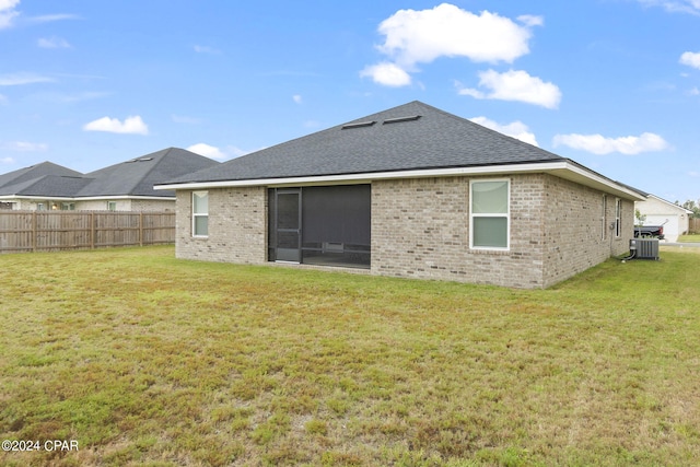 back of house featuring a lawn and central AC unit