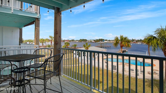 balcony with a community pool and a water view