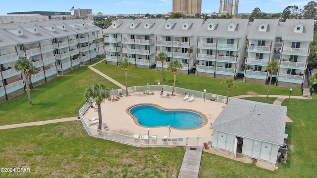 view of pool featuring a patio and a yard