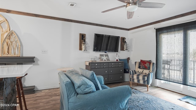 living room with ceiling fan, crown molding, and wood-type flooring