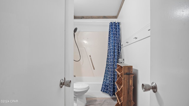 bathroom with shower / bath combination with curtain and toilet