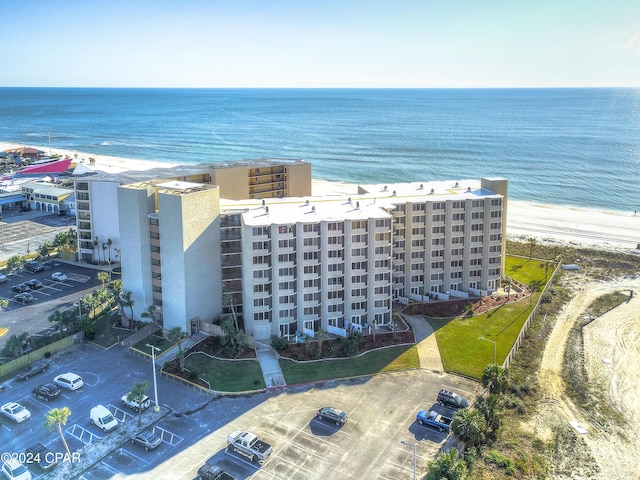 drone / aerial view featuring a water view and a beach view