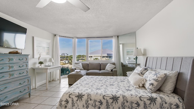 tiled bedroom featuring a textured ceiling and ceiling fan