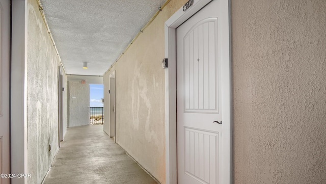 hallway featuring a textured ceiling