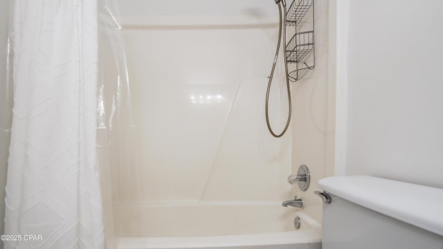 bathroom featuring shower / bath combo and toilet