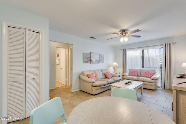 living room featuring visible vents, ceiling fan, and light tile patterned floors