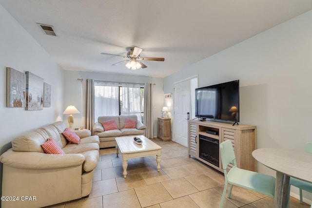 living area with light tile patterned flooring, visible vents, and a ceiling fan