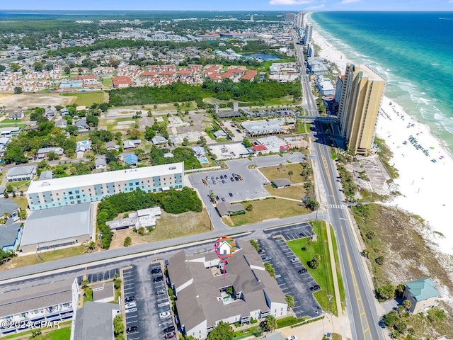 drone / aerial view featuring a water view and a beach view