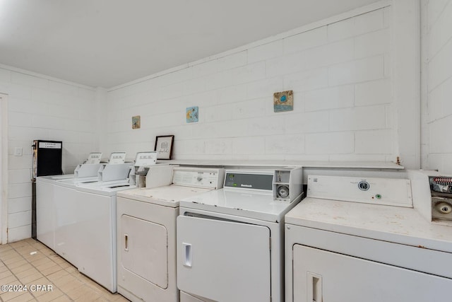 community laundry room featuring light tile patterned floors and washer and dryer