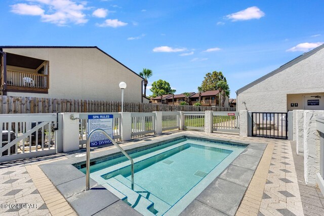 view of pool featuring fence