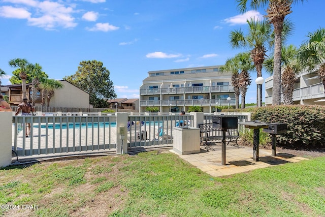 community pool featuring a patio area and fence