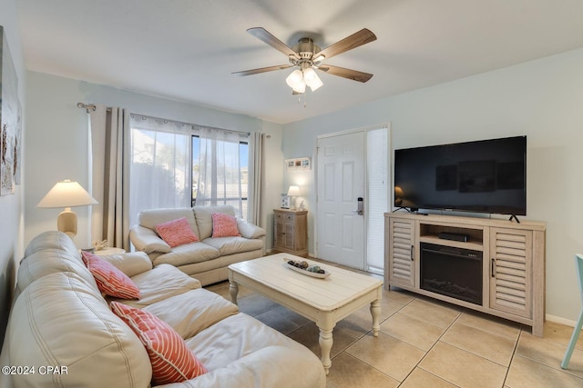 living room with a ceiling fan and light tile patterned flooring