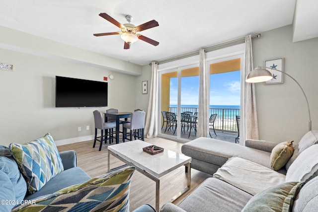 living room featuring ceiling fan and light hardwood / wood-style floors