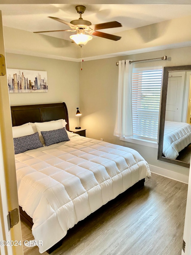 bedroom featuring crown molding, ceiling fan, and wood-type flooring