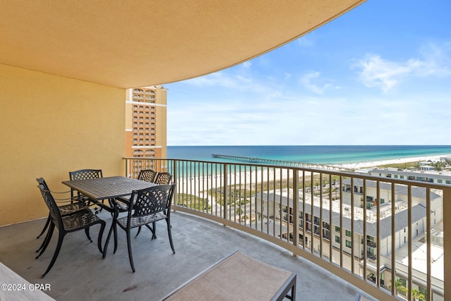 balcony featuring a beach view and a water view