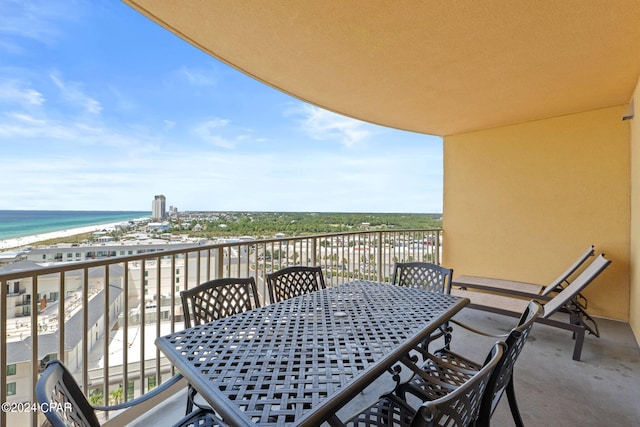 balcony featuring a water view and a view of the beach