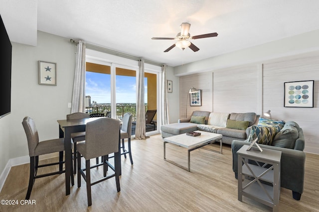 living room with ceiling fan and light hardwood / wood-style floors