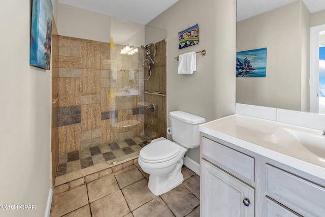 bathroom with toilet, vanity, tile patterned flooring, and a walk in shower