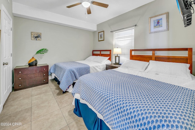 tiled bedroom featuring ceiling fan