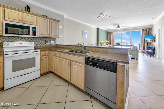 kitchen featuring a peninsula, light brown cabinetry, stainless steel appliances, a sink, and light tile patterned floors