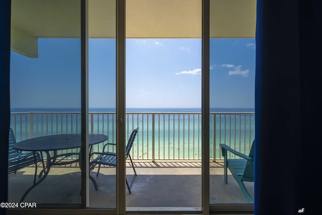 sunroom featuring a water view