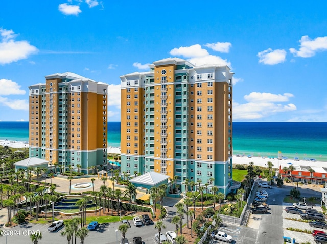 view of property with a beach view and a water view