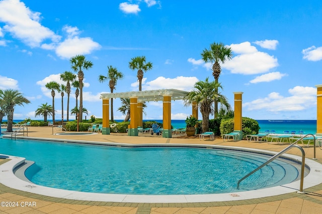 view of swimming pool with a water view, a pergola, and a patio area