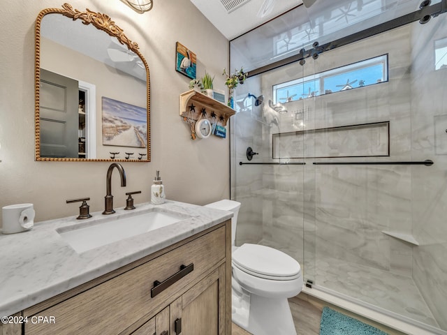 bathroom featuring vanity, toilet, a textured ceiling, a shower with shower door, and hardwood / wood-style floors