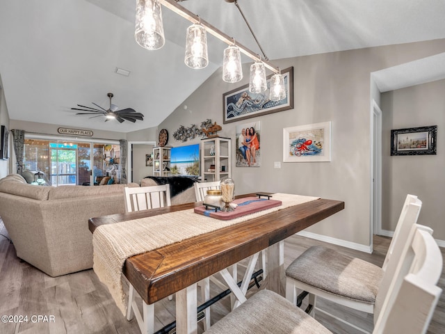 dining space with vaulted ceiling, ceiling fan, and hardwood / wood-style flooring