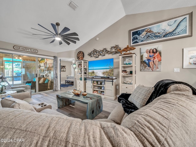 living room with light wood-type flooring, vaulted ceiling, and ceiling fan