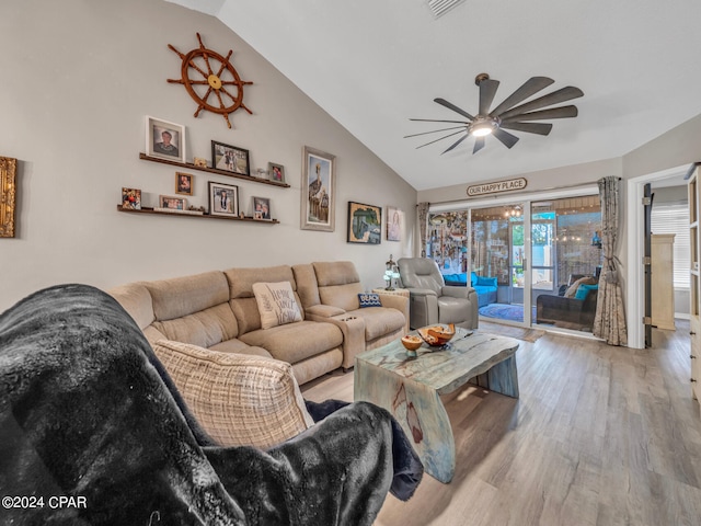 living room with light hardwood / wood-style floors, ceiling fan, and high vaulted ceiling