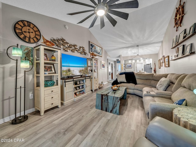 living room with light wood-type flooring, ceiling fan with notable chandelier, lofted ceiling, and a textured ceiling