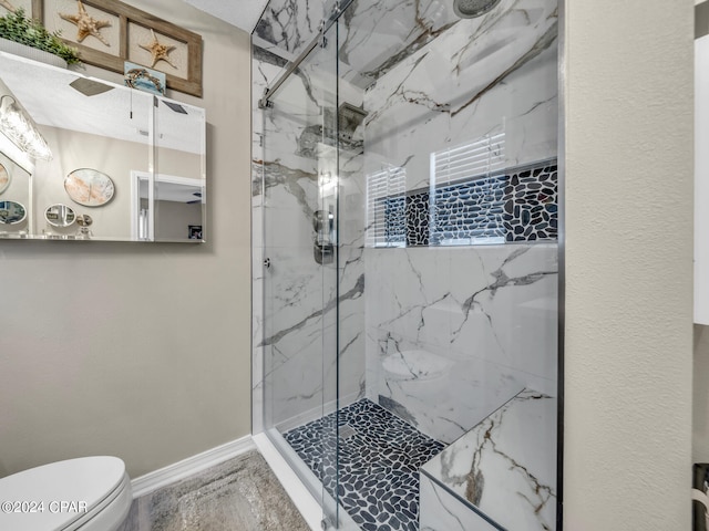 bathroom featuring ceiling fan, walk in shower, and toilet