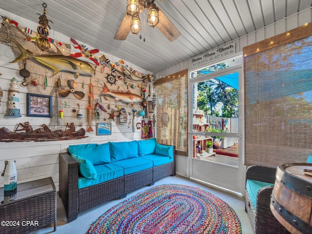 sunroom / solarium featuring ceiling fan