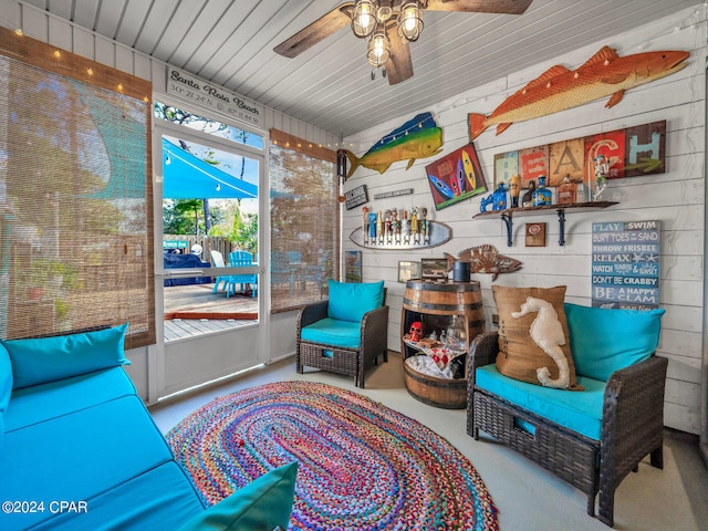 sitting room with concrete flooring and ceiling fan