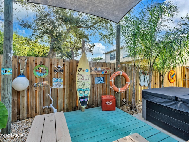 wooden terrace featuring a hot tub