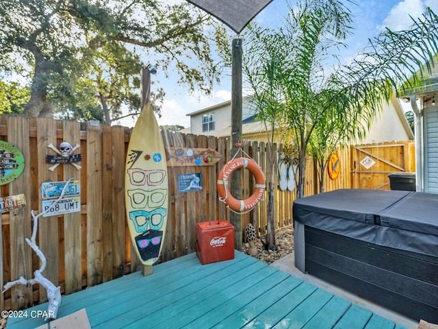 wooden deck with a hot tub