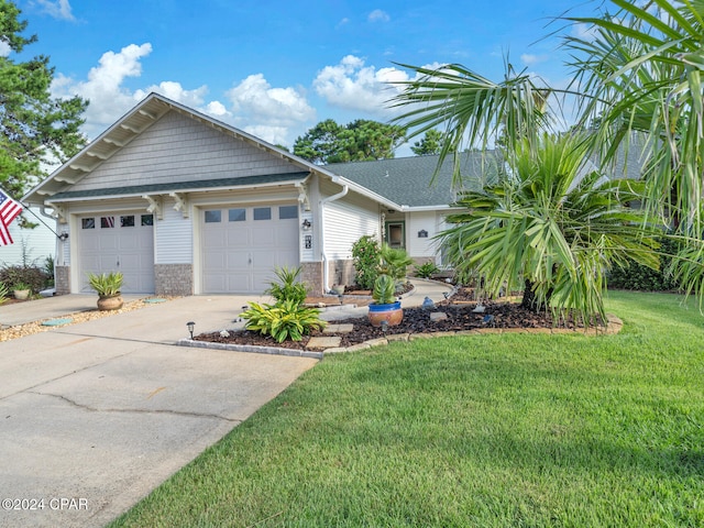 view of front of house with a front yard and a garage