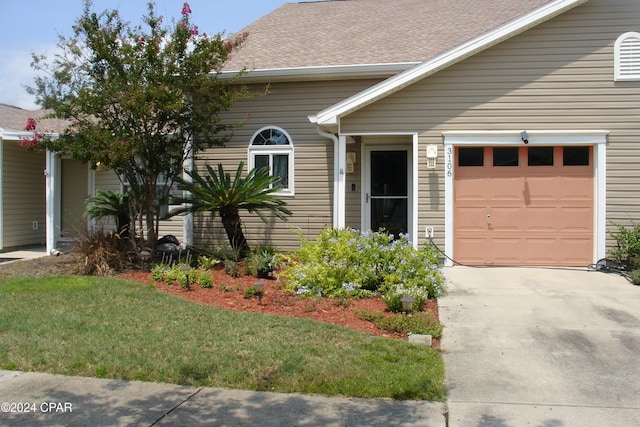 view of front of house featuring a front yard and a garage