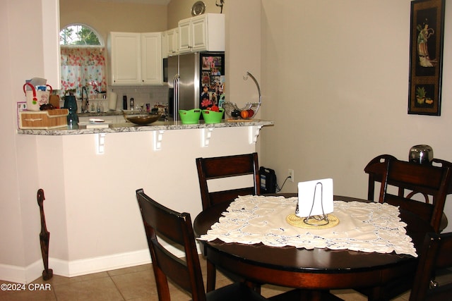 tiled dining area featuring sink