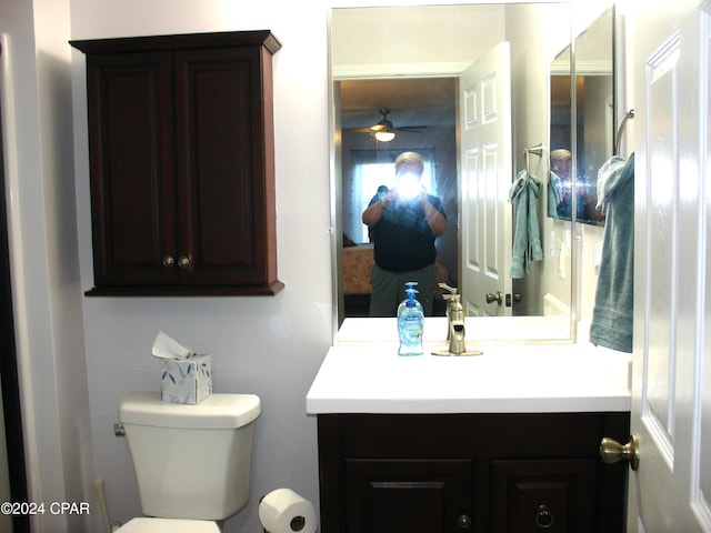 bathroom with ceiling fan, toilet, and vanity