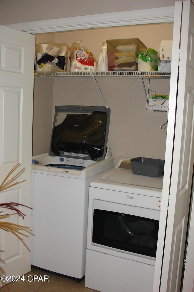 washroom with tile patterned floors and washing machine and dryer