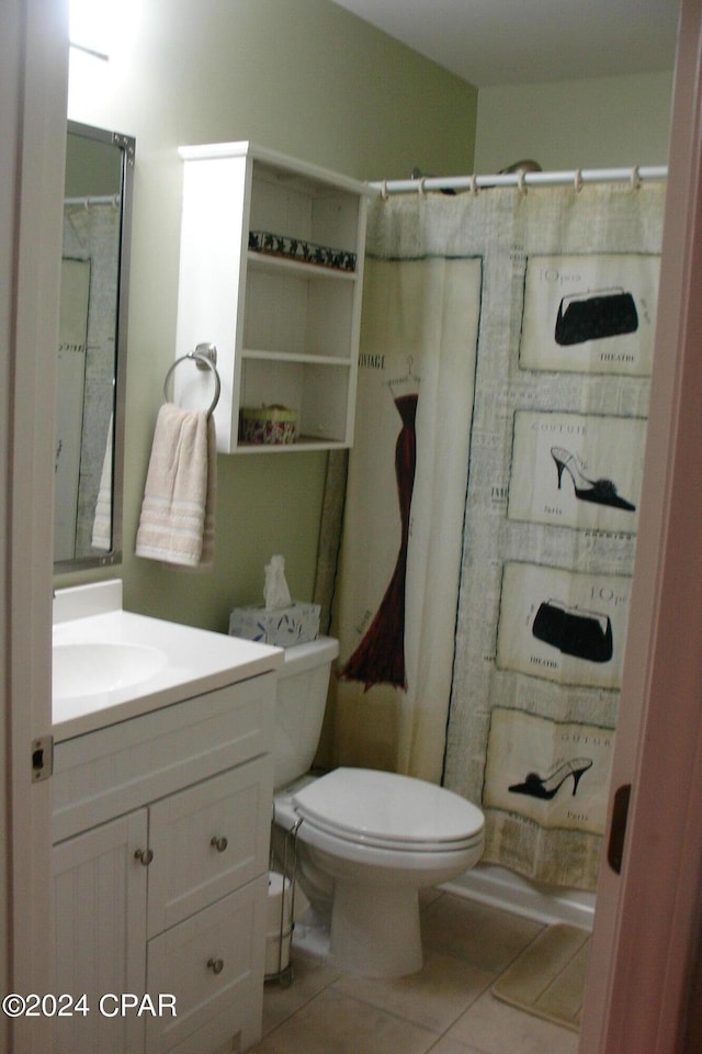 bathroom featuring toilet, vanity, tile patterned floors, and walk in shower